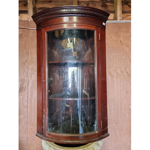 1648 - An antique mahogany hanging bowfront corner cupboard, 95cm high.