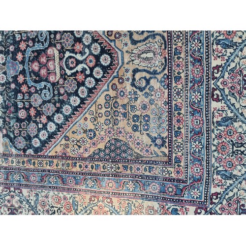 1001 - A large Persian rug, having central floral urn, with floral scrolls to side, borders decorated with ... 