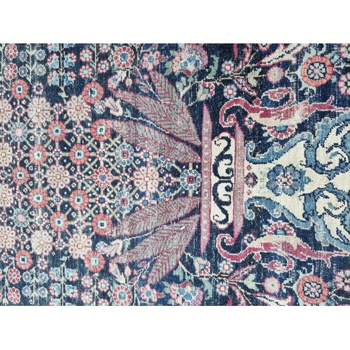 1001 - A large Persian rug, having central floral urn, with floral scrolls to side, borders decorated with ... 