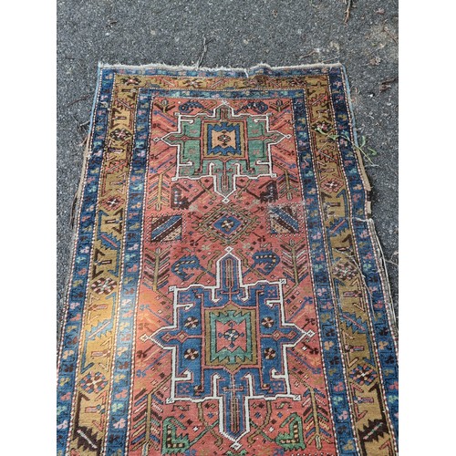 1002 - A Caucasian runner, having five central medallions, with geometric borders, 330 x 92cm.... 