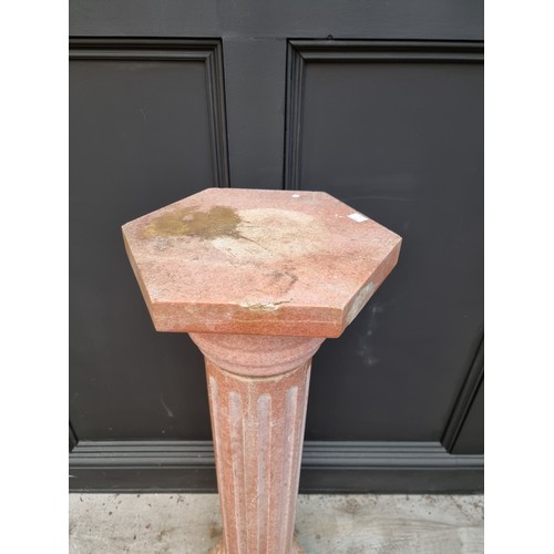 1031 - A pink marble pedestal, with hexagonal top & base and fluted column, 101.5cm high.... 