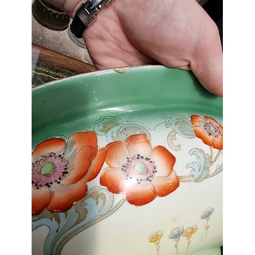 1310A - A large Art Nouveau pottery 'Poppy' pattern basin, 42.5cm diameter.