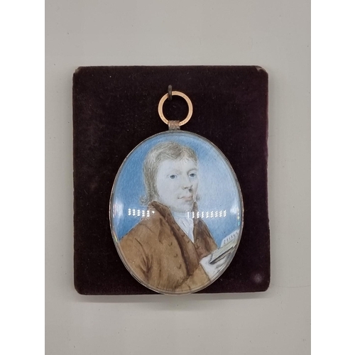 1525 - English School, 18th century, bust length portrait miniature of a gentleman holding a book, on ... 