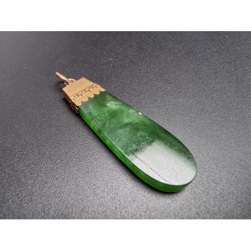 185 - A yellow metal jadeite pendant, stamped '18c', 46mm including bale.