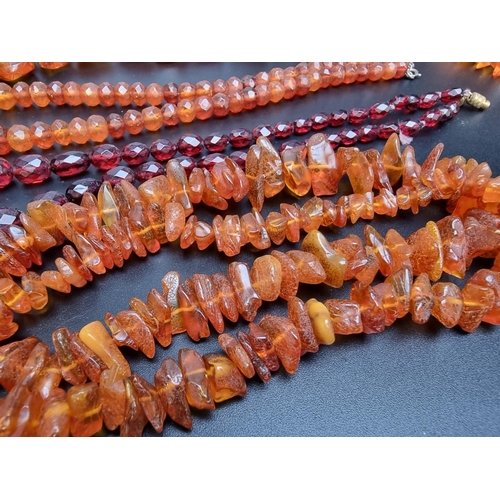 221 - A 'cherry amber' graduated and facetted bead necklace, 47cm long; together with three amber necklace... 