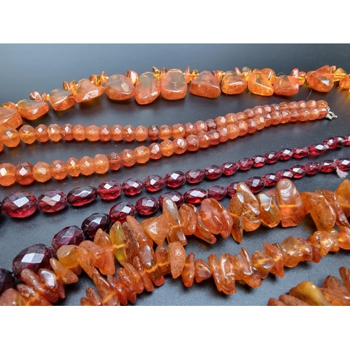 221 - A 'cherry amber' graduated and facetted bead necklace, 47cm long; together with three amber necklace... 