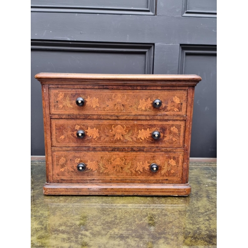 1062 - Miniature Furniture: a good Victorian walnut and marquetry three drawer chest, with ivory inset knob... 