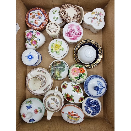 1378 - A collection of small porcelain boxes and covers.