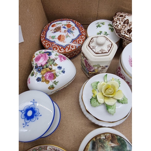 1378 - A collection of small porcelain boxes and covers.