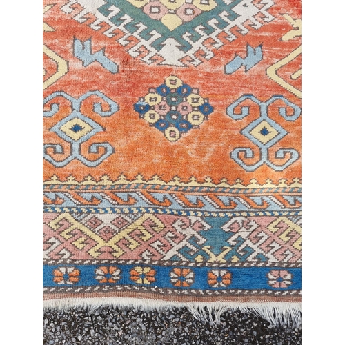 1000 - A Tribal rug, having geometric decoration to central field, with floral borders, 251 x 171cm.... 
