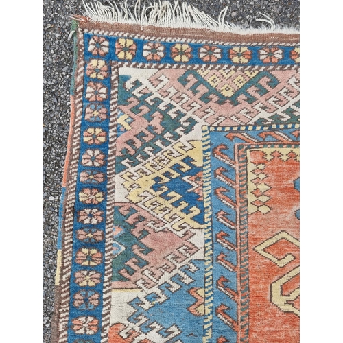 1000 - A Tribal rug, having geometric decoration to central field, with floral borders, 251 x 171cm.... 