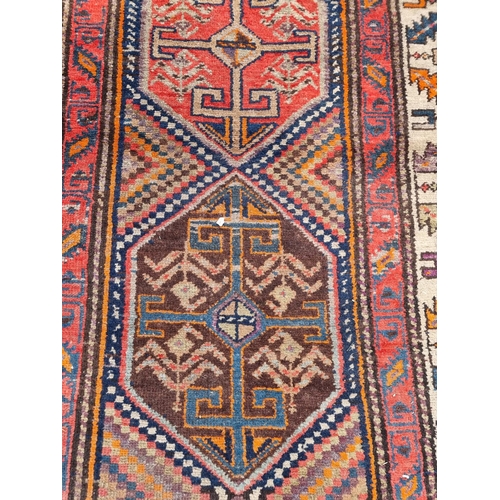1009 - A Tribal rug, having four central medallions, with geometric design, 260 x 102cm; together with a sm... 