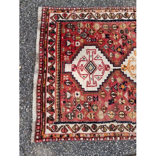 1009 - A Tribal rug, having four central medallions, with geometric design, 260 x 102cm; together with a sm... 