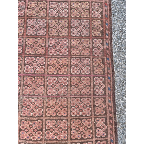 1011 - A small Bokhara rug, having repeated decoration, 150 x 94cm.