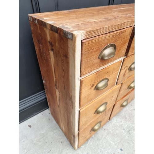1022 - An old pine multi-drawer chest, 78cm high x 132cm wide x 35.5cm deep. 