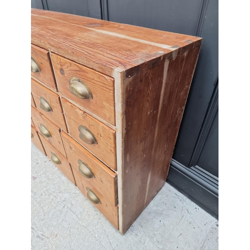 1022 - An old pine multi-drawer chest, 78cm high x 132cm wide x 35.5cm deep. 