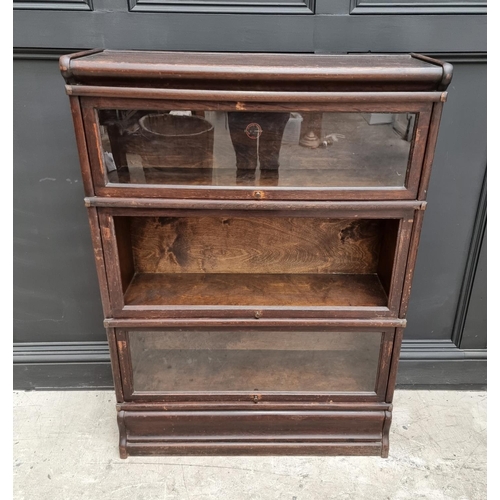 1028 - A Globe Wernicke oak three tier sectional bookcase, 86cm wide, (middle tier lacking glass). ... 