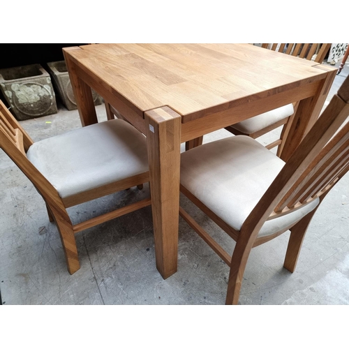 1032 - A contemporary pale oak dining table and four chairs, the table 80cm wide. ... 