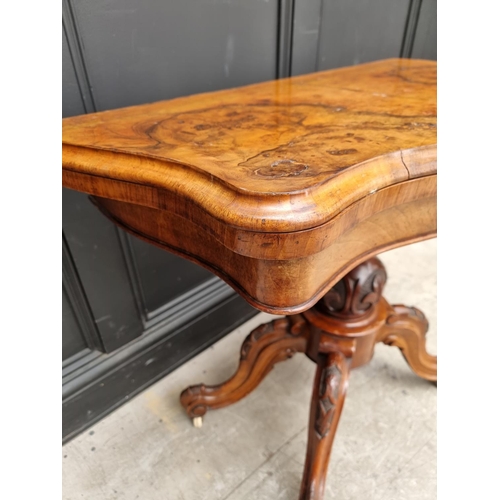 1047 - A Victorian figured and carved walnut pedestal card table, 89cm wide.