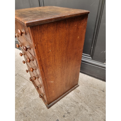 1053 - An old oak collector's type chest, 57cm high x 35cm wide x 31cm deep.