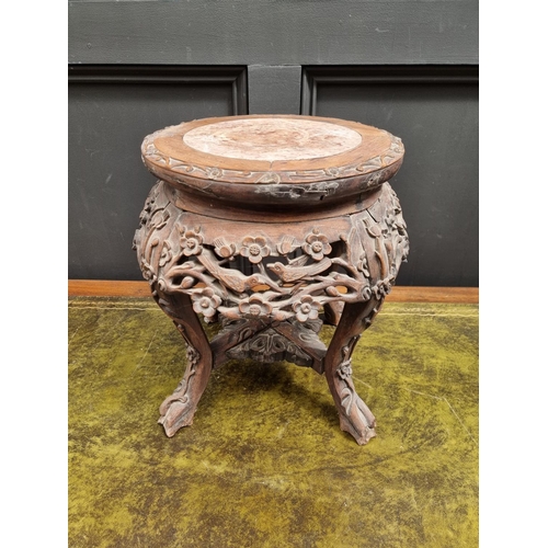 1060 - A Chinese carved hardwood and marble top jardiniere stand, 37cm high. 