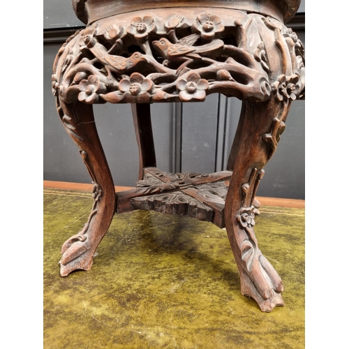 1060 - A Chinese carved hardwood and marble top jardiniere stand, 37cm high. 