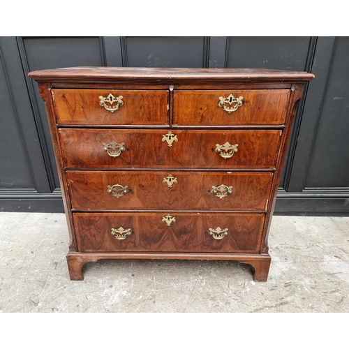 1065 - An 18th century walnut and feathered banded chest of drawers, 102cm wide. 