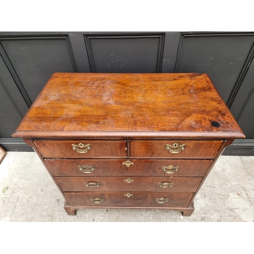 1065 - An 18th century walnut and feathered banded chest of drawers, 102cm wide. 