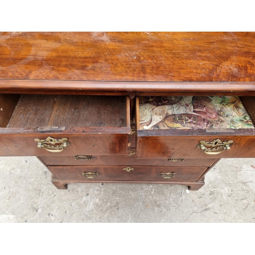 1065 - An 18th century walnut and feathered banded chest of drawers, 102cm wide. 