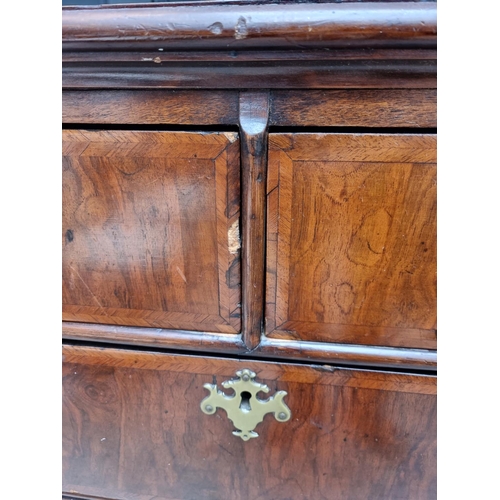 1065 - An 18th century walnut and feathered banded chest of drawers, 102cm wide. 