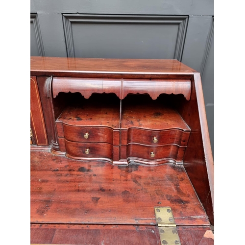 1066 - A George III mahogany and inlaid bureau, 117.5cm wide. 