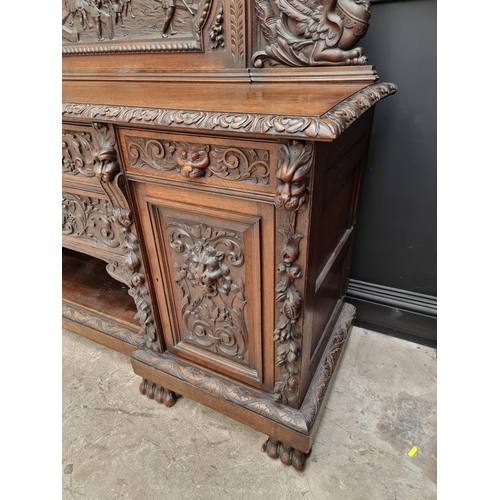 1067 - A large late Victorian carved oak side cabinet, 199cm wide.