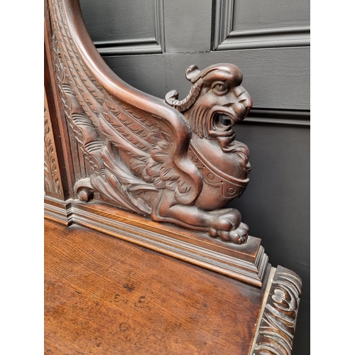 1067 - A large late Victorian carved oak side cabinet, 199cm wide.