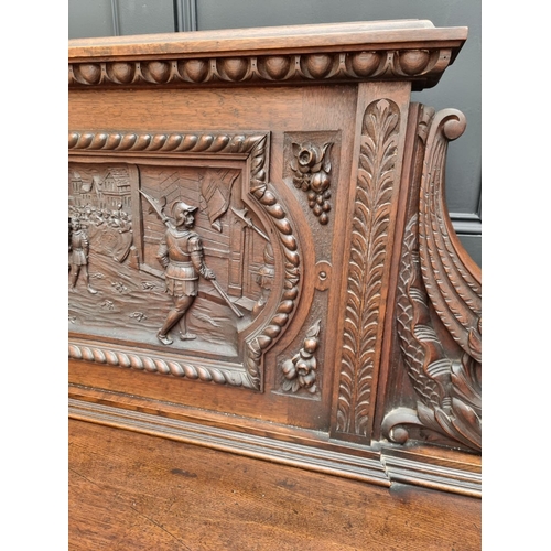 1067 - A large late Victorian carved oak side cabinet, 199cm wide.