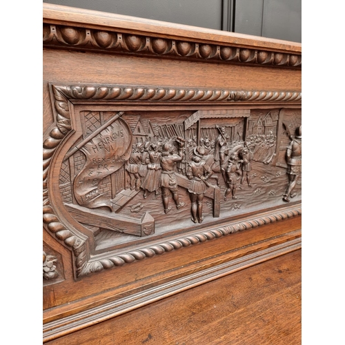 1067 - A large late Victorian carved oak side cabinet, 199cm wide.