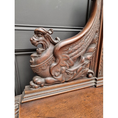 1067 - A large late Victorian carved oak side cabinet, 199cm wide.