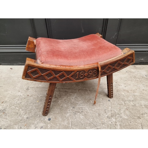 1072 - An unusual Victorian carved walnut saddle stool, initialled 'W R' and dated 1893, 55.5cm wide.&... 