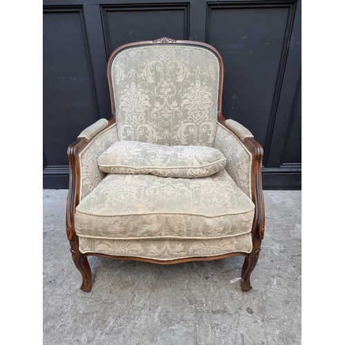 1076 - A beechwood and damask upholstered occasional armchair and matching stool. 