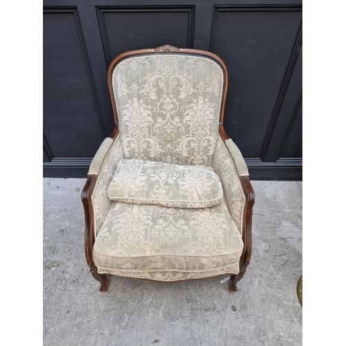 1076 - A beechwood and damask upholstered occasional armchair and matching stool. 