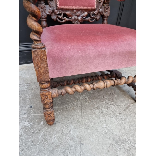 1077 - A late Victorian carved oak and upholstered open arm occasional chair. 