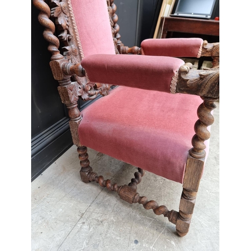 1077 - A late Victorian carved oak and upholstered open arm occasional chair. 