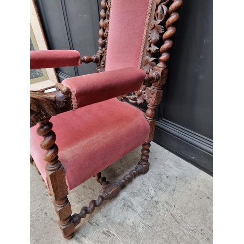 1077 - A late Victorian carved oak and upholstered open arm occasional chair. 