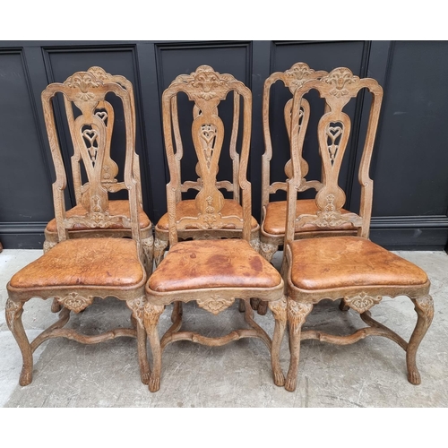 1088 - A set of six early 18th century style limed oak and tan leather dining chairs, with carved decoratio... 