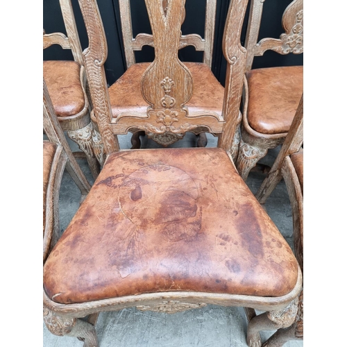 1088 - A set of six early 18th century style limed oak and tan leather dining chairs, with carved decoratio... 