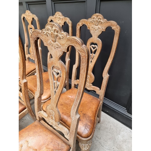 1088 - A set of six early 18th century style limed oak and tan leather dining chairs, with carved decoratio... 