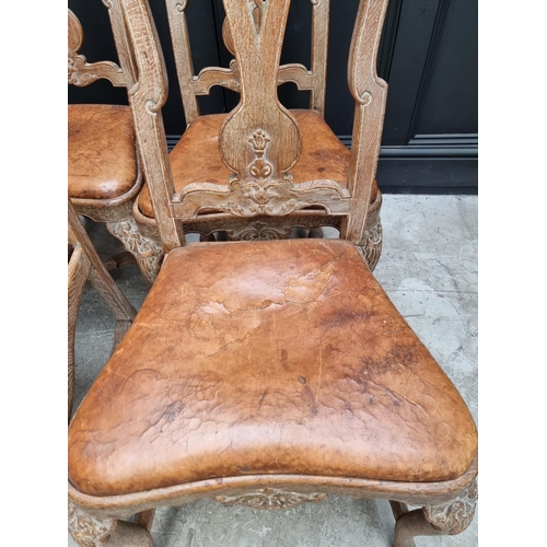 1088 - A set of six early 18th century style limed oak and tan leather dining chairs, with carved decoratio... 