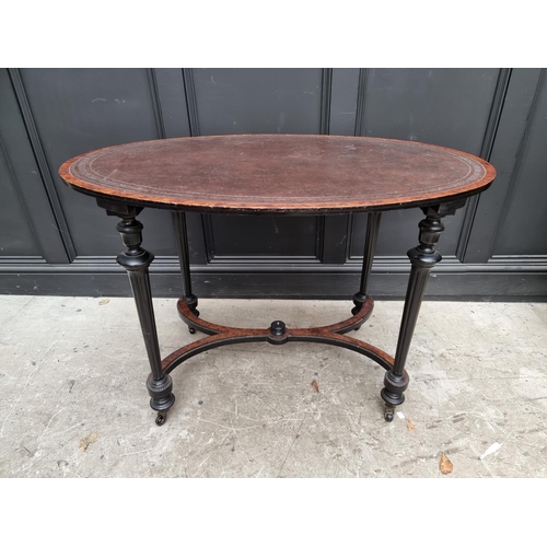 1090 - A late 19th century ebonized and burr yew oval centre table, with leather inset top, 106cm wide... 