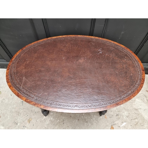 1090 - A late 19th century ebonized and burr yew oval centre table, with leather inset top, 106cm wide... 