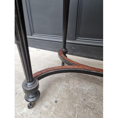 1090 - A late 19th century ebonized and burr yew oval centre table, with leather inset top, 106cm wide... 