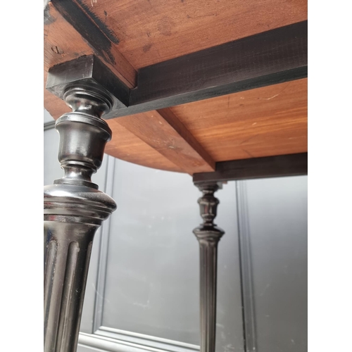 1090 - A late 19th century ebonized and burr yew oval centre table, with leather inset top, 106cm wide... 